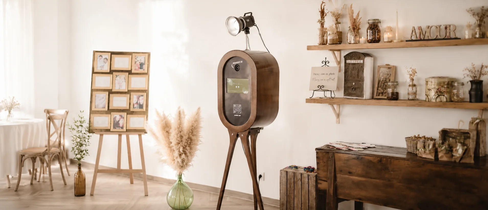 Photobooth vintage en bois installé lors d'un mariage à Toulon, décor bohème avec pampas